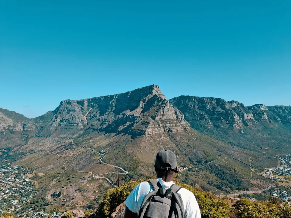 A solo hiker overlooking Table Mountain in Cape Town